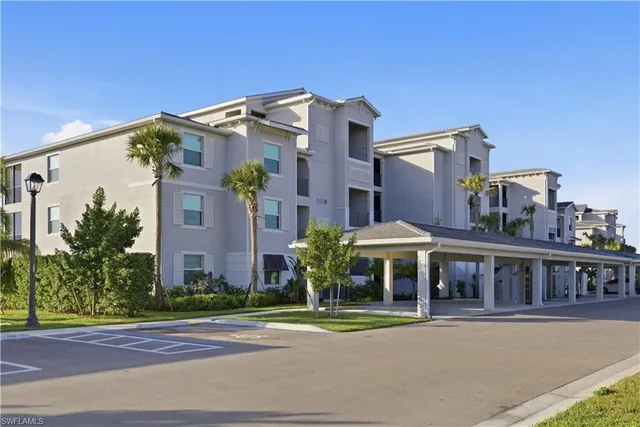 a front view of a house with a yard and table and chairs