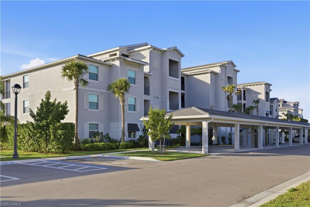 5555 Double Eagle Circle, Unit 3915 Ave Maria, FL 34142 - Photo 3 of 33 a front view of a house with a yard and table and chairs