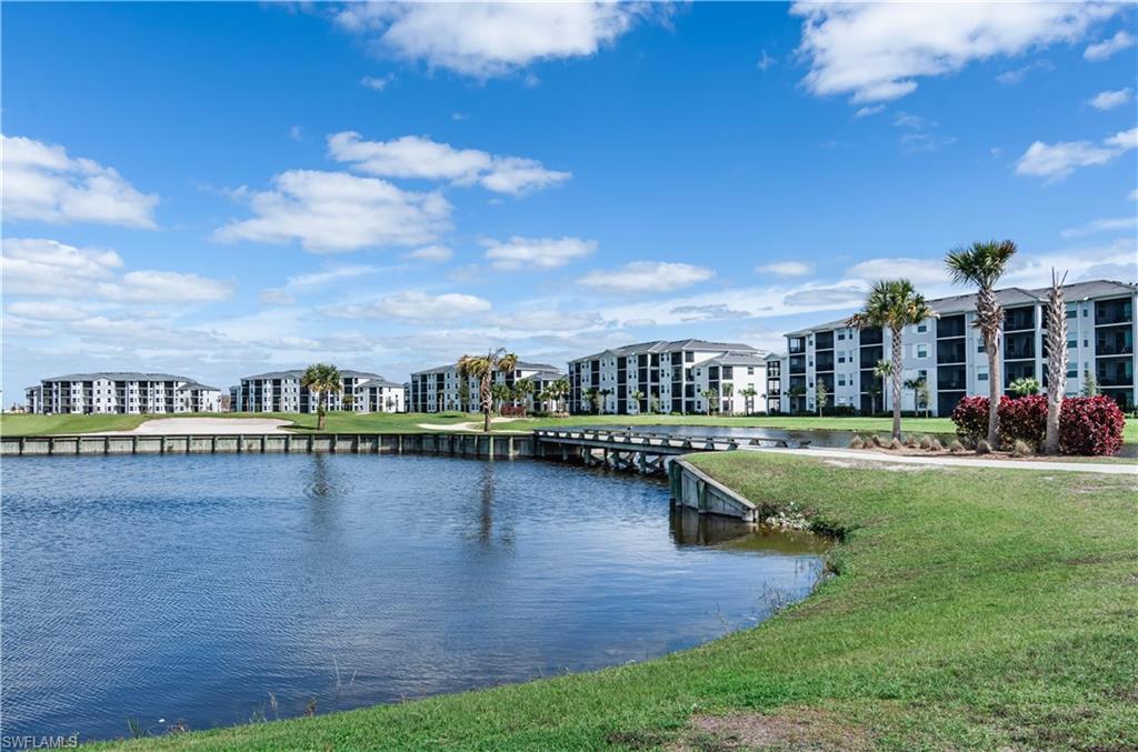 5555 Double Eagle Circle, Unit 3915 Ave Maria, FL 34142 - Photo 6 of 33 a view of swimming pool with outdoor seating and lake view