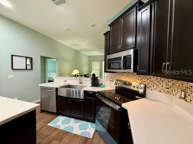 86351 Moonlit Walk Circle Yulee, FL 32097 - Photo 15 of 53 a kitchen with stainless steel appliances granite countertop a sink stove microwave and refrigerator