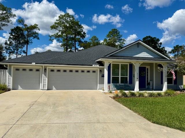 86351 Moonlit Walk Circle Yulee, FL 32097 - Photo 4 of 53 a front view of a house with a garden