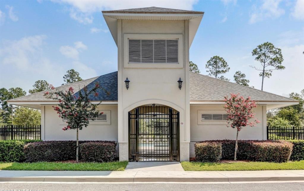 86351 Moonlit Walk Circle Yulee, FL 32097 - Photo 50 of 53 a front view of a house with a yard and garage
