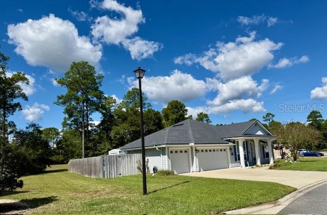 86351 Moonlit Walk Circle Yulee, FL 32097 - Photo 7 of 53 a view of a house with a yard