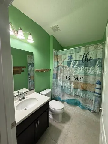 a bathroom with a sink mirror toilet and shower