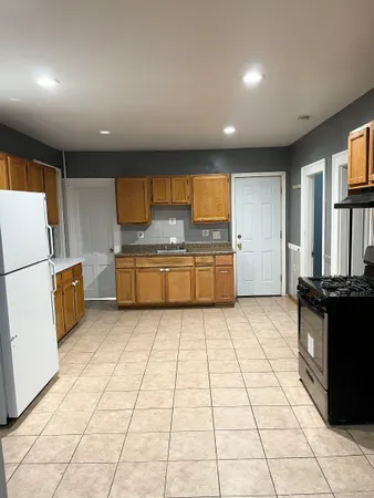 a kitchen with stainless steel appliances granite countertop a refrigerator a stove a sink and a microwave