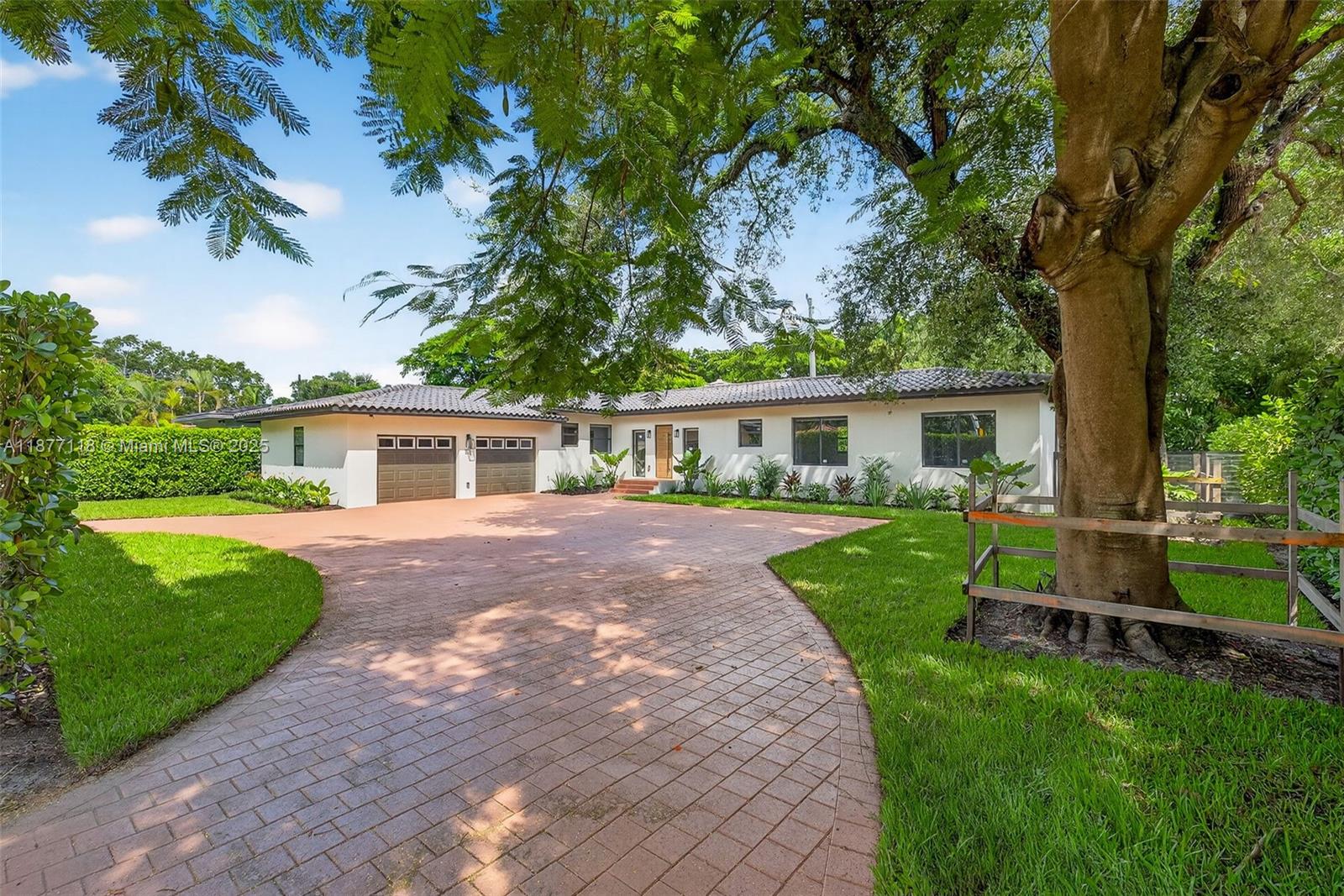 635 Bird Road Coral Gables, FL 33146 - Photo 1 of 25 a front view of a house with a garden