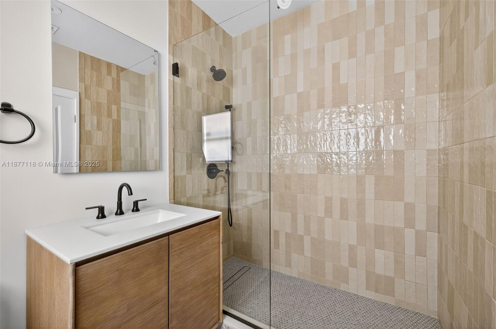 635 Bird Road Coral Gables, FL 33146 - Photo 11 of 25 a bathroom with a sink and a mirror