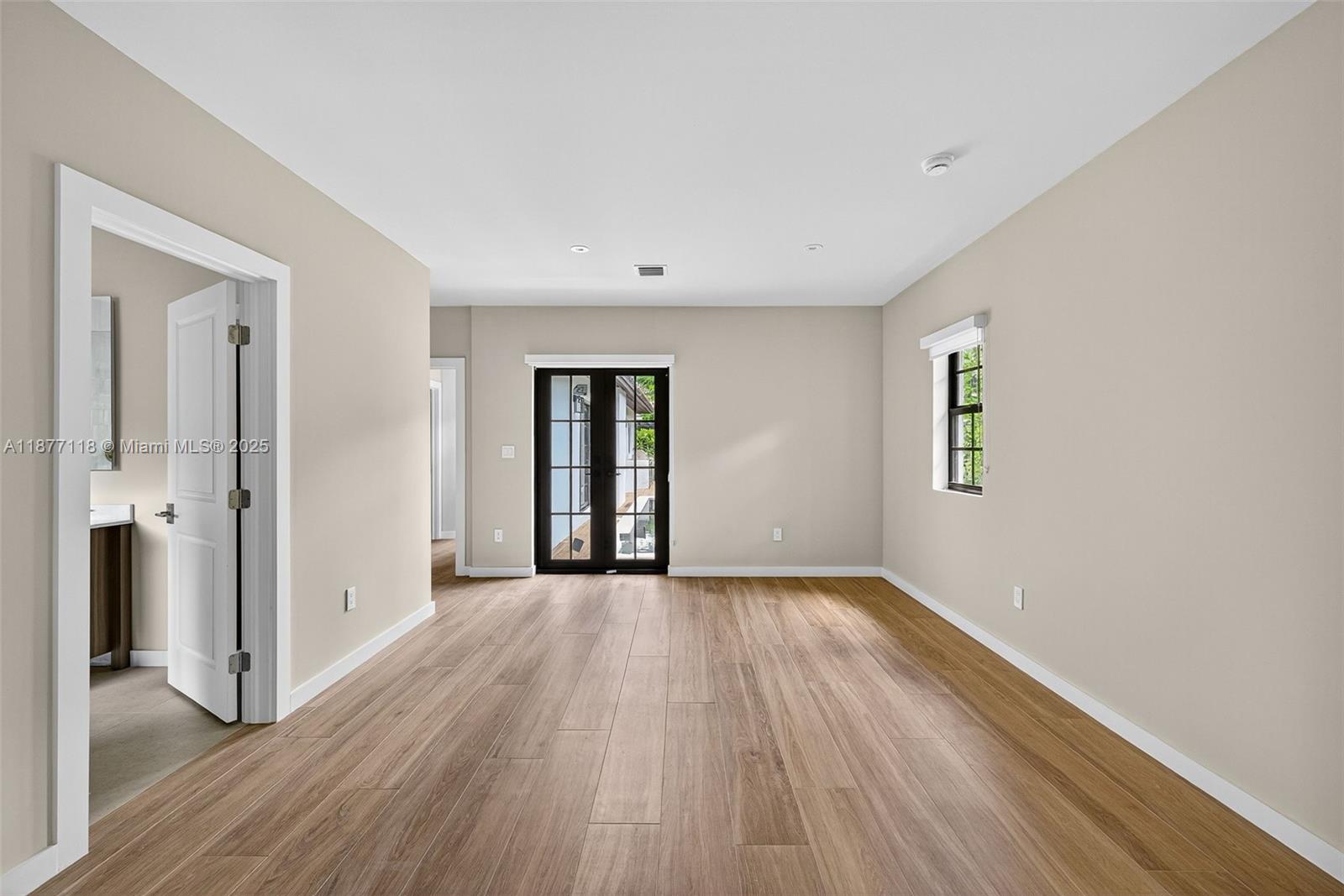 635 Bird Road Coral Gables, FL 33146 - Photo 13 of 25 wooden floor in an empty room with a window