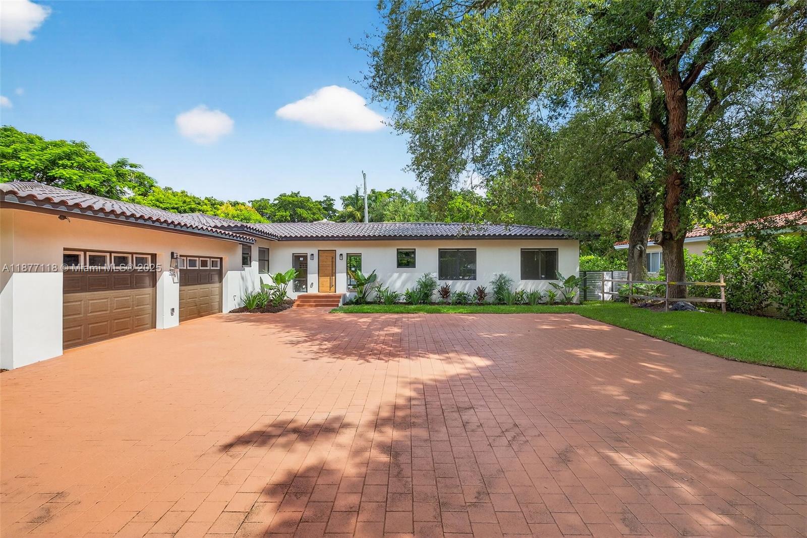 635 Bird Road Coral Gables, FL 33146 - Photo 2 of 25 a front view of house with a garden
