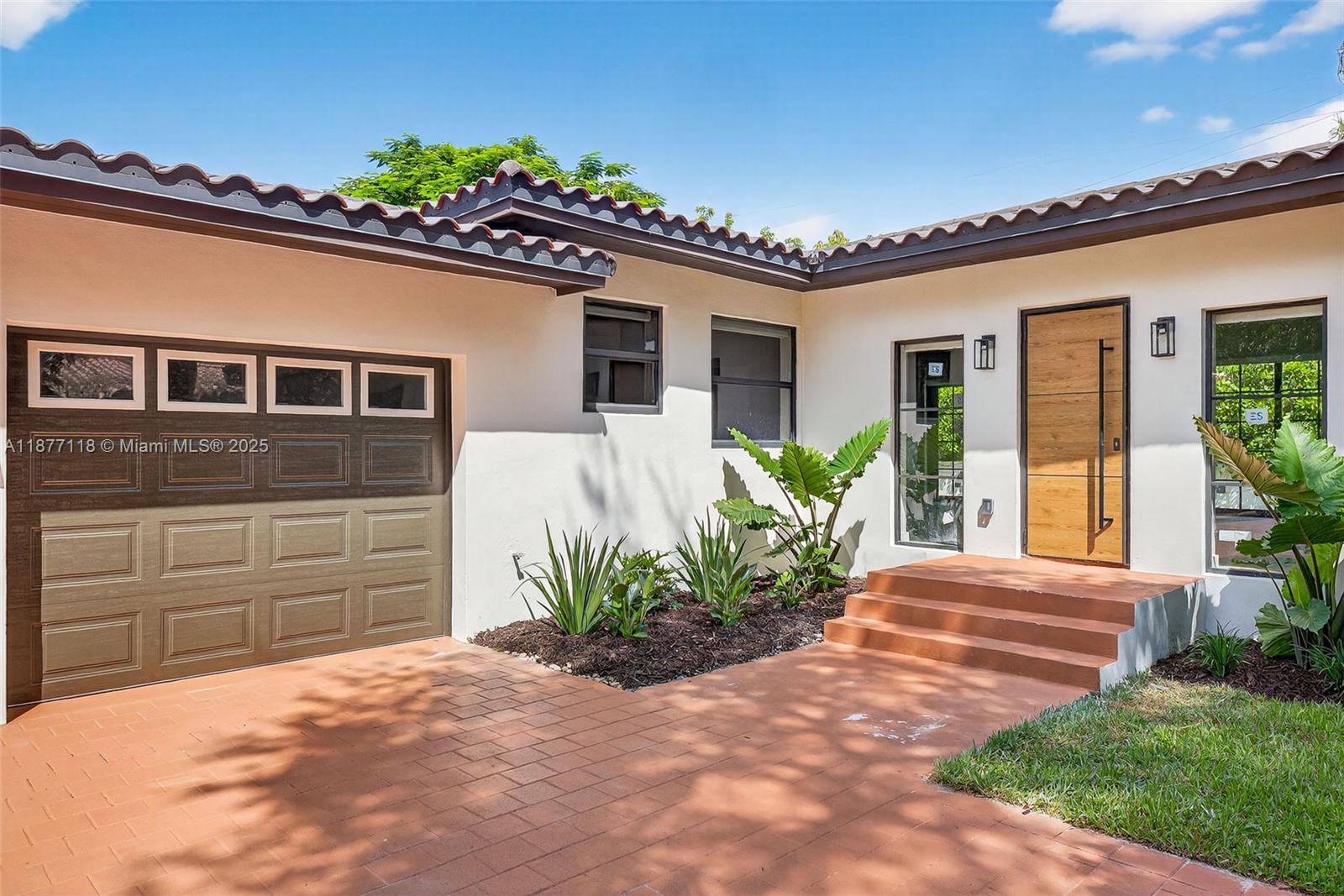 635 Bird Road Coral Gables, FL 33146 - Photo 3 of 25 a front view of a house with a yard