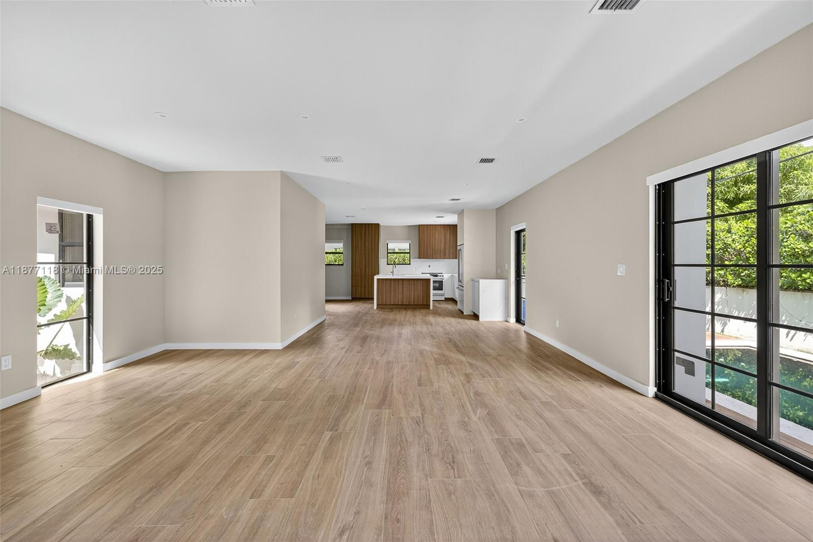 635 Bird Road Coral Gables, FL 33146 - Photo 4 of 25 a view of empty room with wooden floor and fan