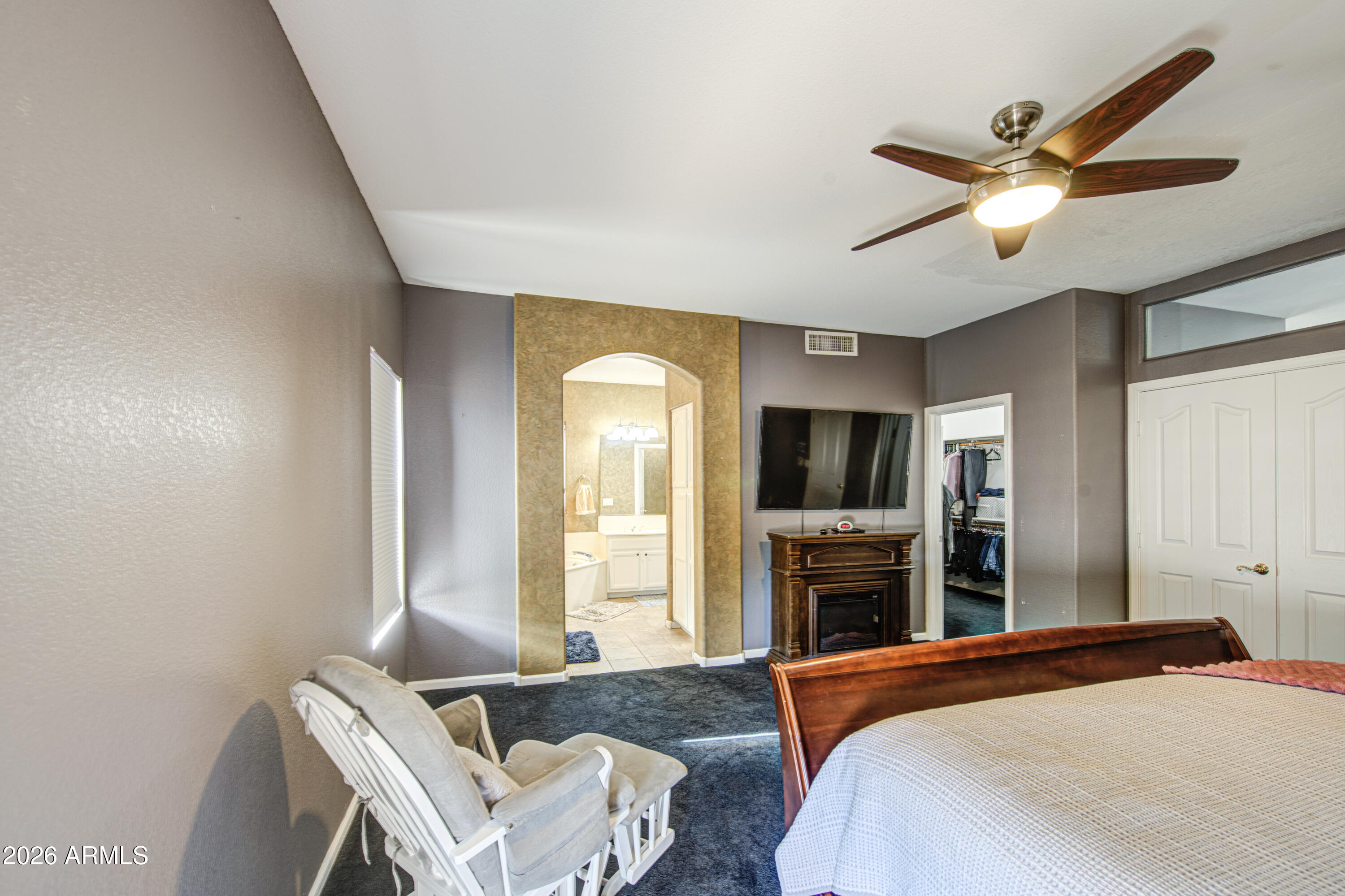 12403 West Monte Vista Road Avondale, AZ 85392 - Photo 30 of 63 a bedroom with a bed and a fireplace
