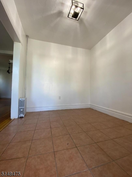 46 Prospect Street, Unit 2 Bloomfield, NJ 07003 - Photo 11 of 33 a view of a room with an empty space and a fireplace