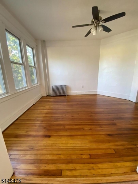 46 Prospect Street, Unit 2 Bloomfield, NJ 07003 - Photo 13 of 33 a view of empty room with wooden floor and fan