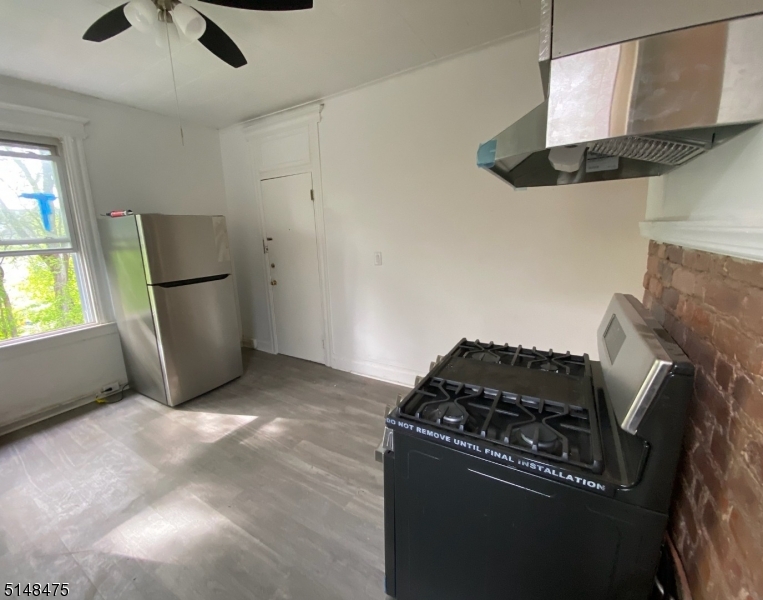 46 Prospect Street, Unit 2 Bloomfield, NJ 07003 - Photo 22 of 33 a kitchen with stainless steel appliances granite countertop a refrigerator and a stove