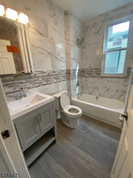 46 Prospect Street, Unit 2 Bloomfield, NJ 07003 - Photo 7 of 33 a bathroom with a sink a toilet and bathtub