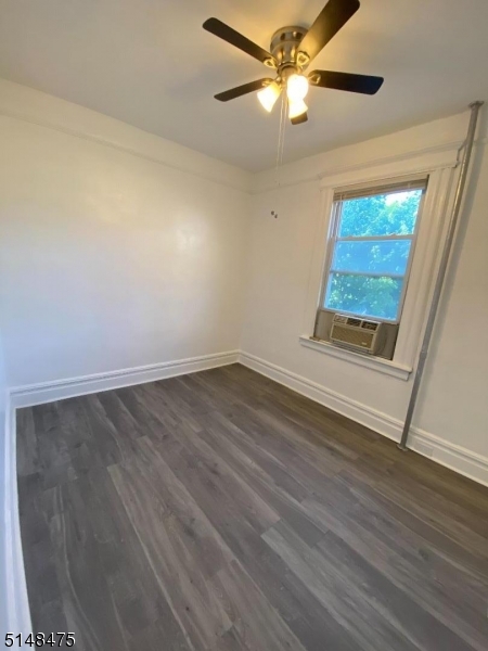 46 Prospect Street, Unit 2 Bloomfield, NJ 07003 - Photo 9 of 33 an empty room with wooden floor fan and windows