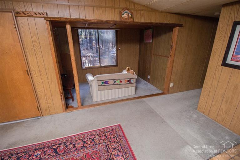 16804 Covina Road Bend, OR 97707 - Photo 6 of 16 a view of a hallway with wooden floor and windows