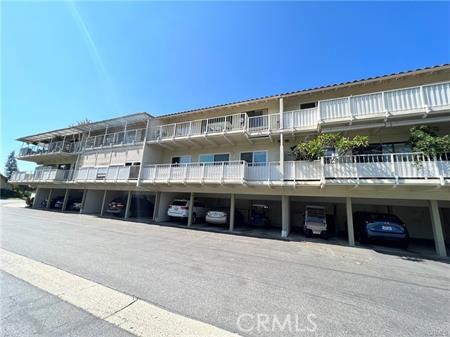 863 Ronda Mendoza, Unit B Laguna Woods, CA 92637 - Photo 35 of 37 a large building with a large window