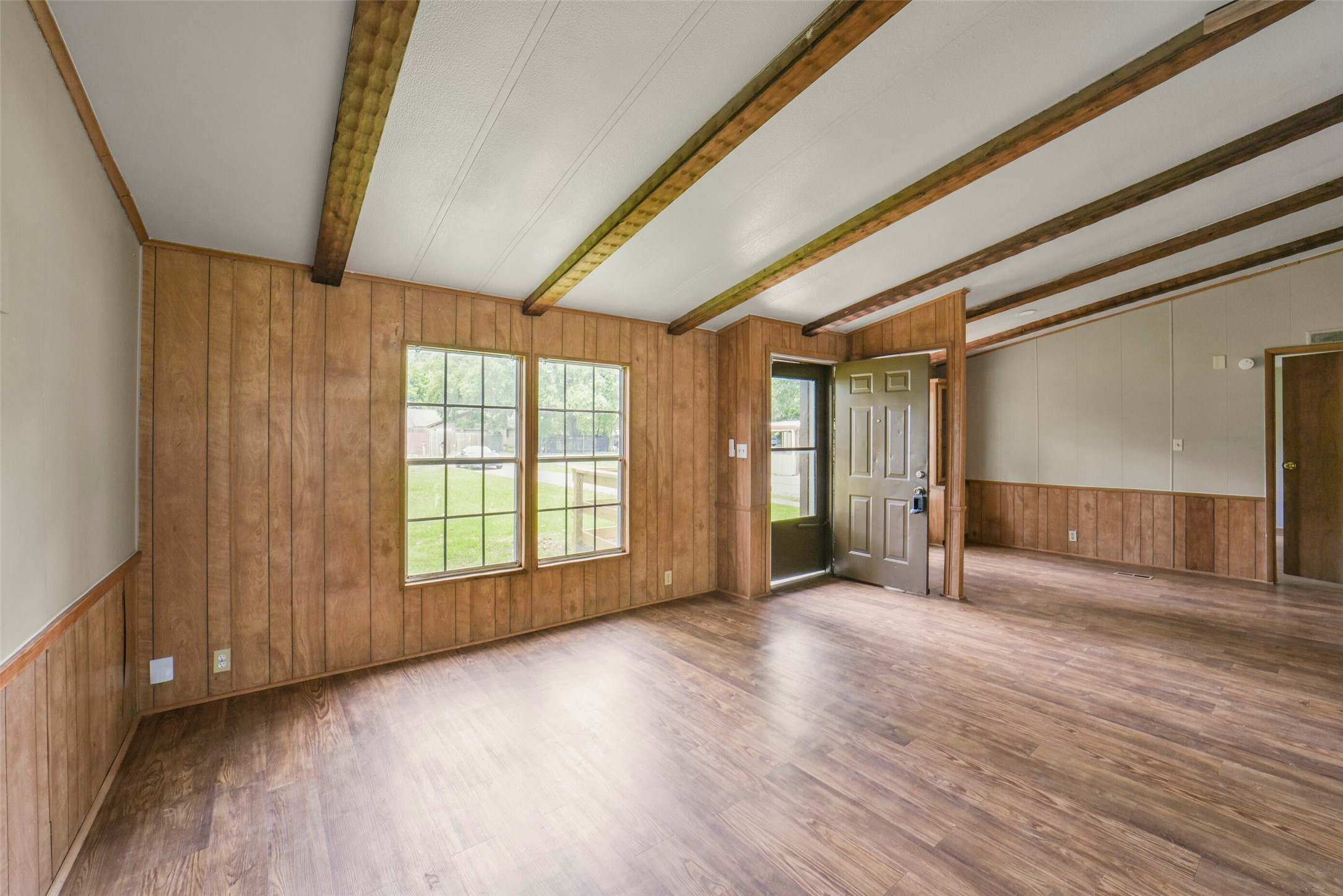 11023 Forrest Valley Drive Houston, TX 77065 - Photo 7 of 47 a view of an empty room with wooden floor and a window