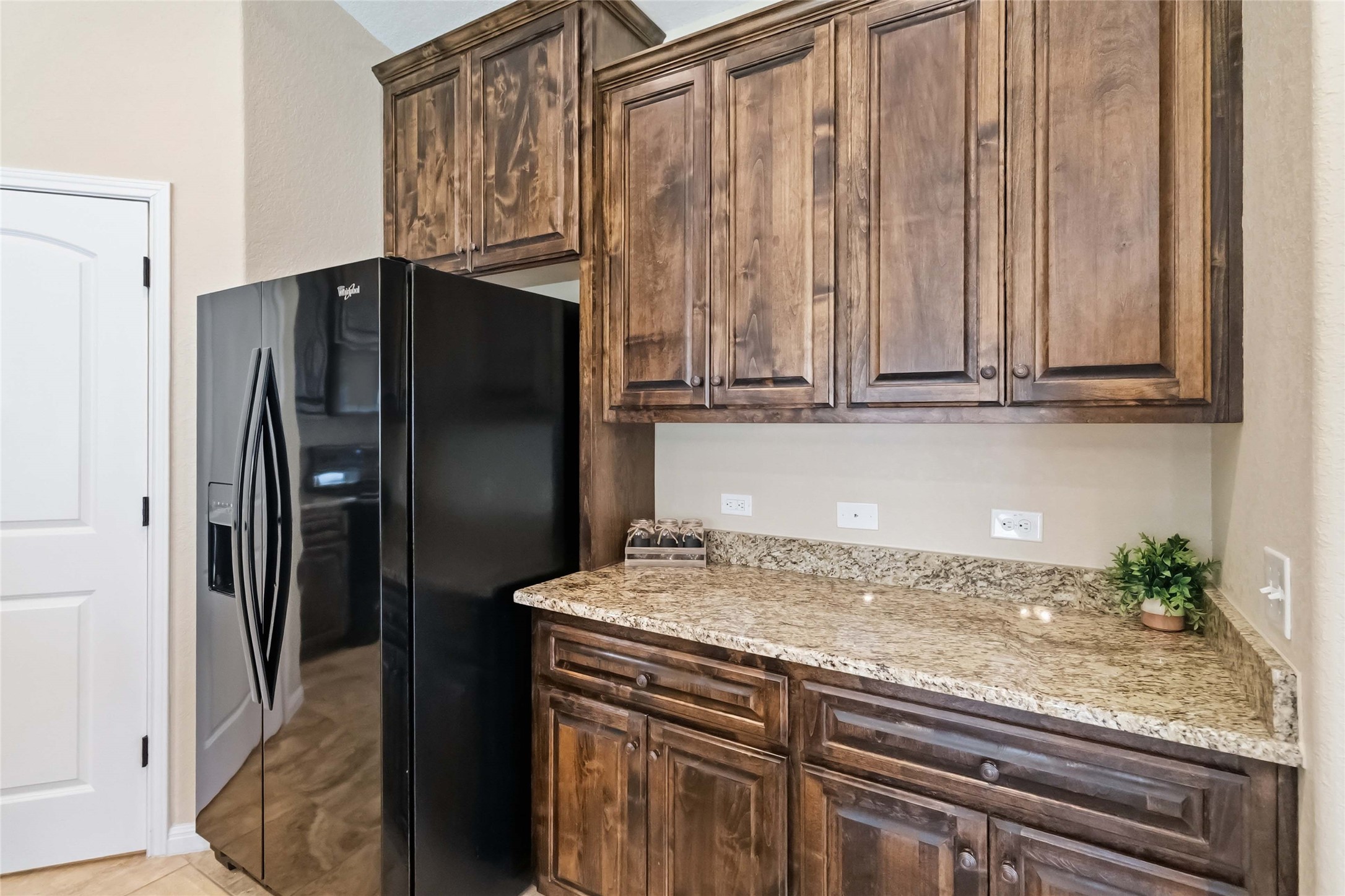 285 Hummingbird Way Martindale, TX 78655 - Photo 8 of 40 a kitchen with granite countertop a refrigerator and a sink