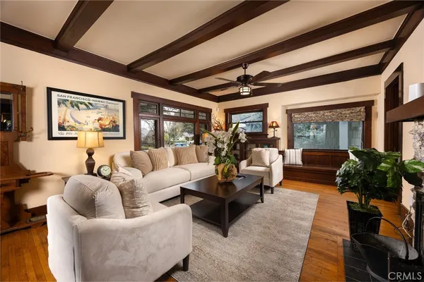 a view of a livingroom with a furniture hardwood floor and a ceiling fan