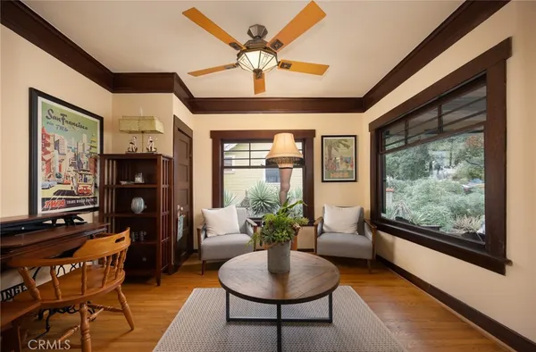 a dining room with furniture a chandelier and wooden floor