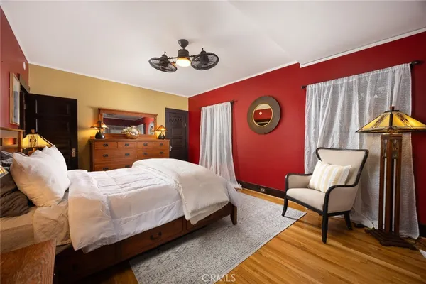 a bedroom with a bed and a mirror on the dresser