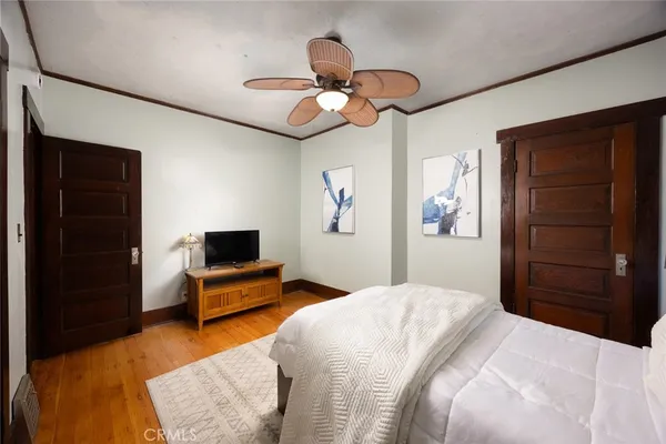 a bed room with a bed and a flat screen tv