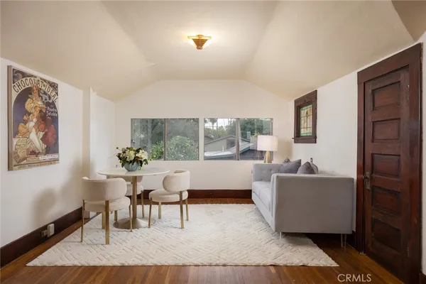 a bathroom with a sink a mirror a toilet and a window