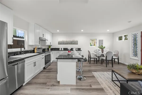 a view of a backyard with table and chairs under an umbrella