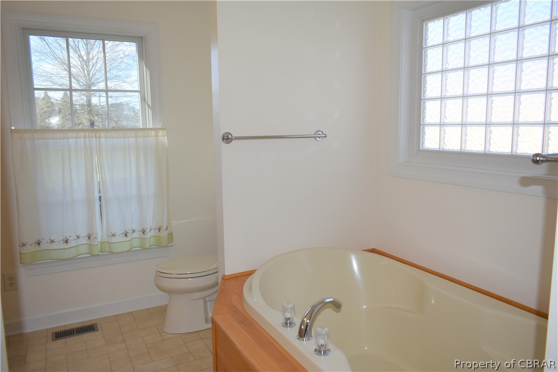163 Mill Lane Road Cardinal, VA 23025 - Photo 30 of 50 a bathroom with a tub and window