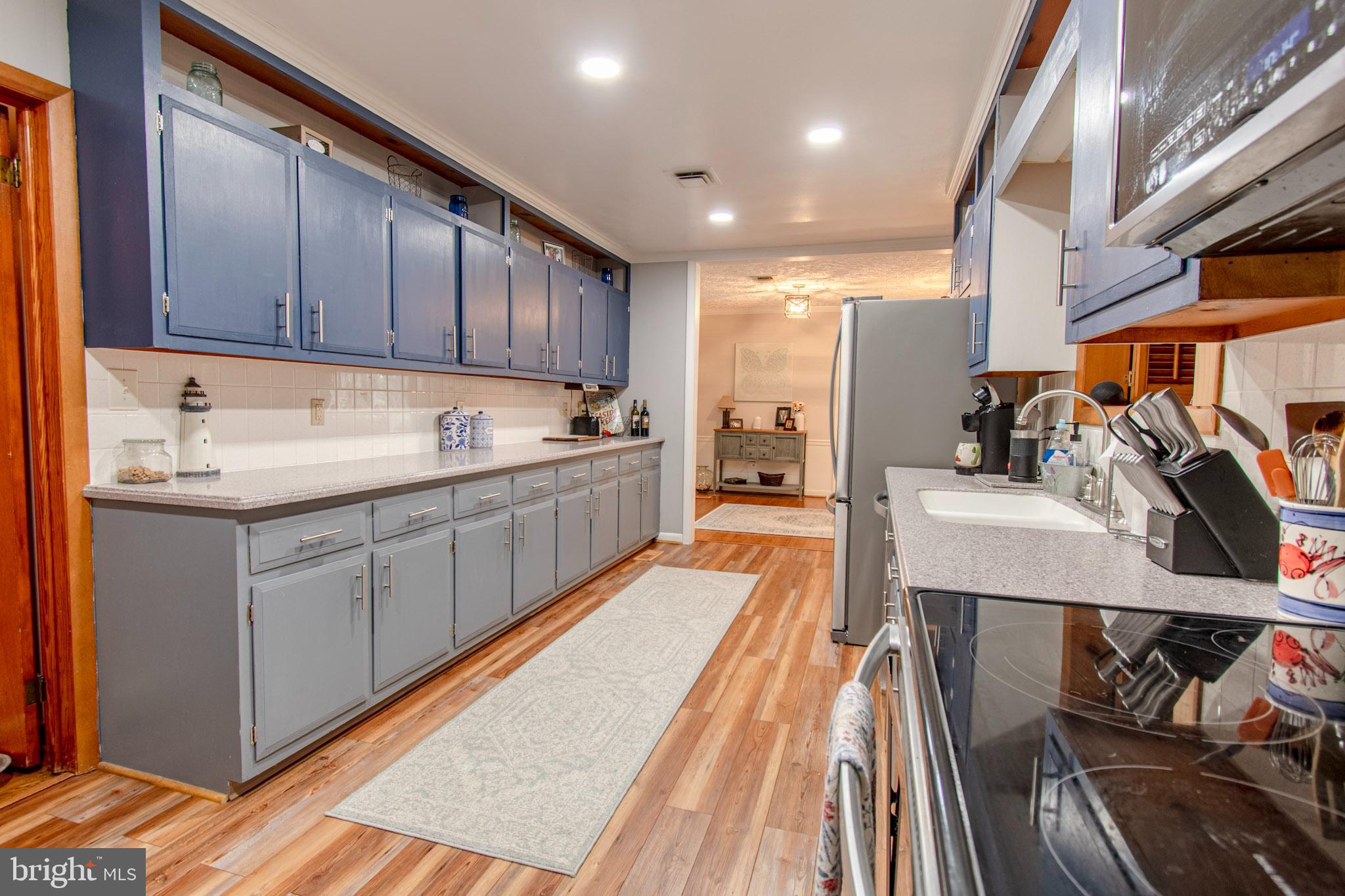 2 Nanticoke Road Cambridge, MD 21613 - Photo 13 of 37 Modern kitchen with sleek cabinetry and warm to...