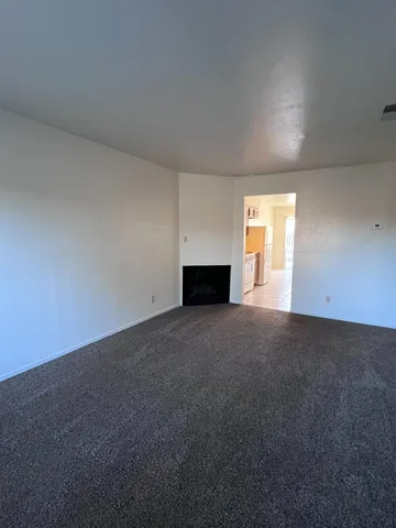 a view of empty room with a fireplace