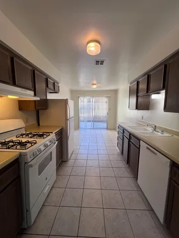 a kitchen with a stove top oven and cabinets