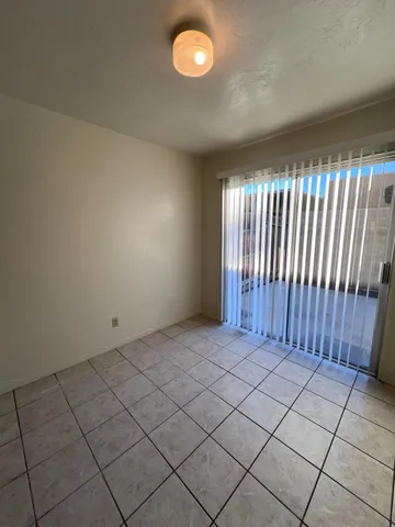 an empty room with staircase and mirror