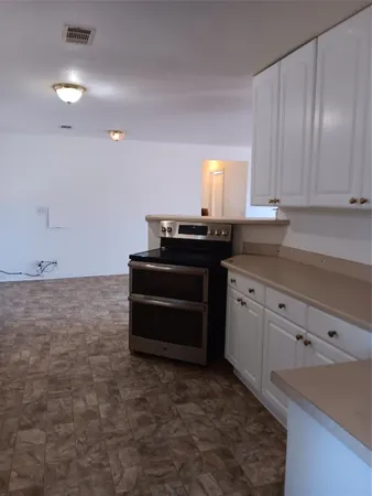 a room with cabinets and piano table