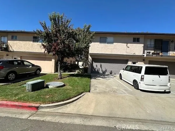 a view of a back yard of the house with car parked