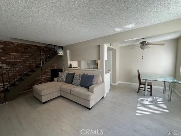 a living room with furniture a rug and a table