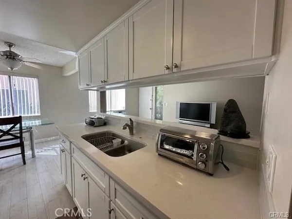a kitchen with a stove a sink and cabinets