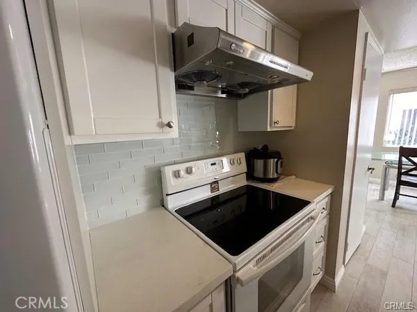 a kitchen with stainless steel appliances a sink and cabinets