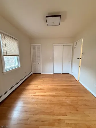 a big room with wooden floor and windows