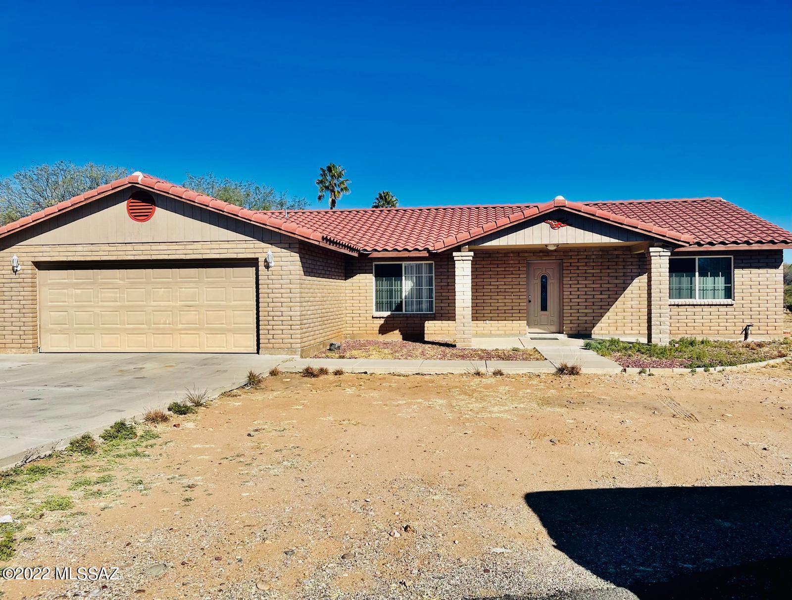 1151 Adobe Court Rio Rico, AZ 85648 - Photo 1 of 13 a front view of a house with a yard