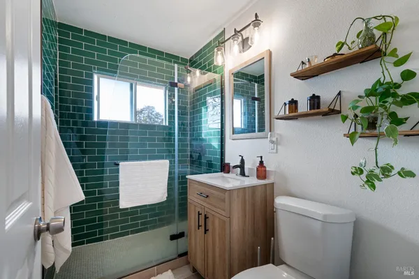 a bathroom with a sink toilet and window