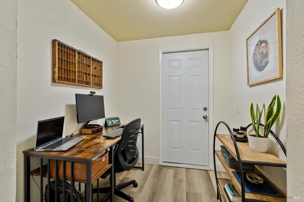 a view of a workspace with furniture and a window