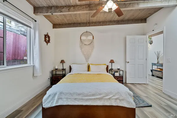 a bed sitting in a bedroom next to a window