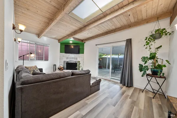 a living room with furniture a fireplace and a potted plant