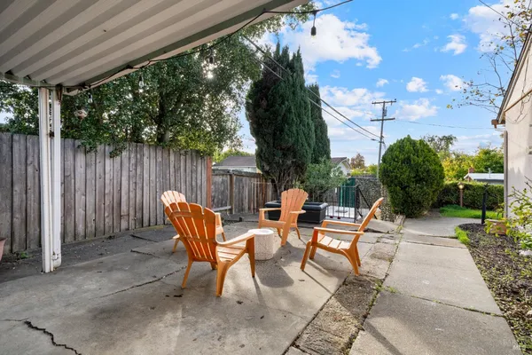 a backyard of a house with table and chairs