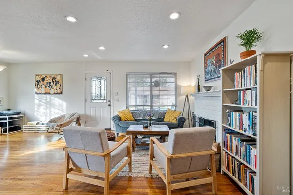 a living room with a lots of furniture and a book shelf