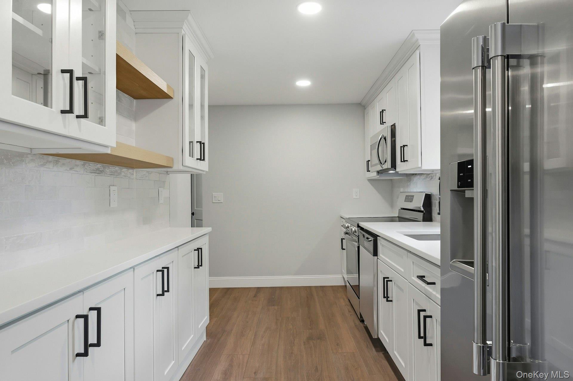 101 Rustic Road Centereach, NY 11720 - Photo 21 of 42 a kitchen with cabinets and wooden floor